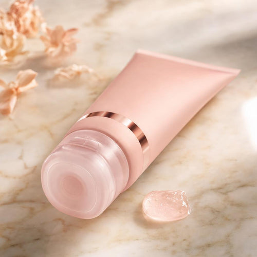 The mask tube resting on marble beside a bead of translucent pink collagen gel